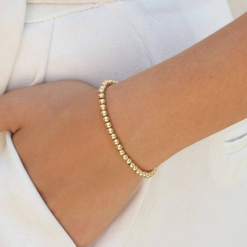 add pendant to this gold stretch bead bracelet