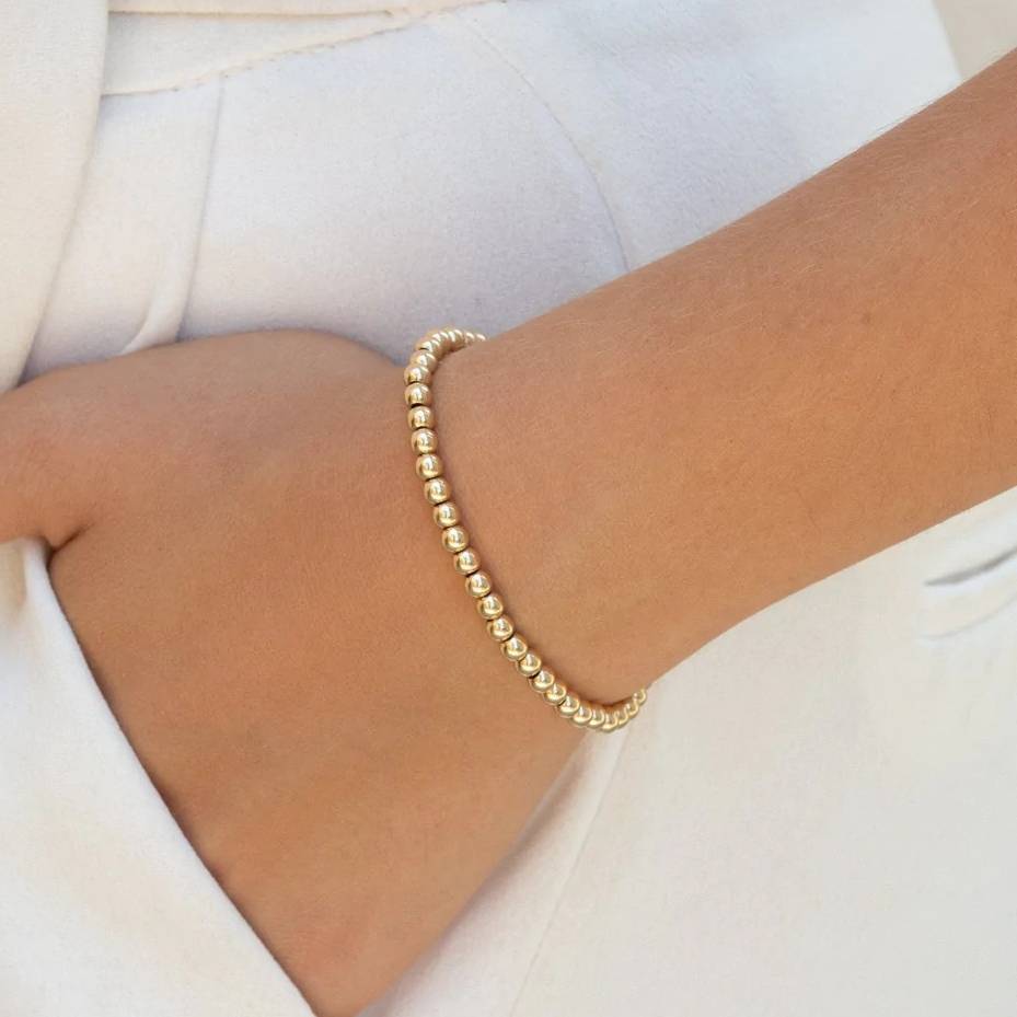 add pendant to this gold stretch bead bracelet