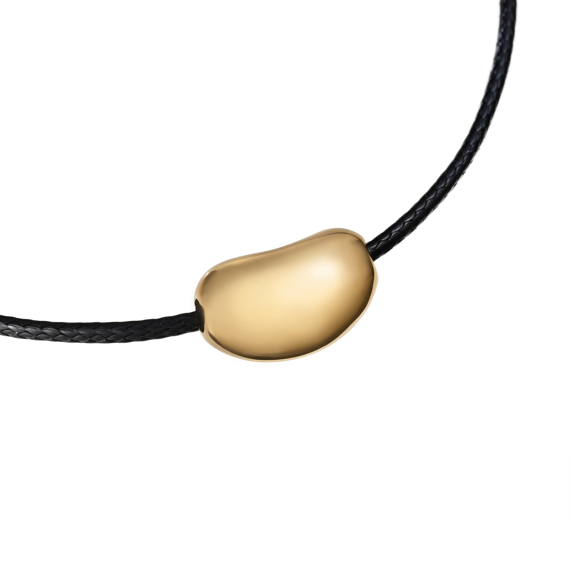 Minimalist gold pebble pendant necklace on black waxed cord, inspired by beach stones