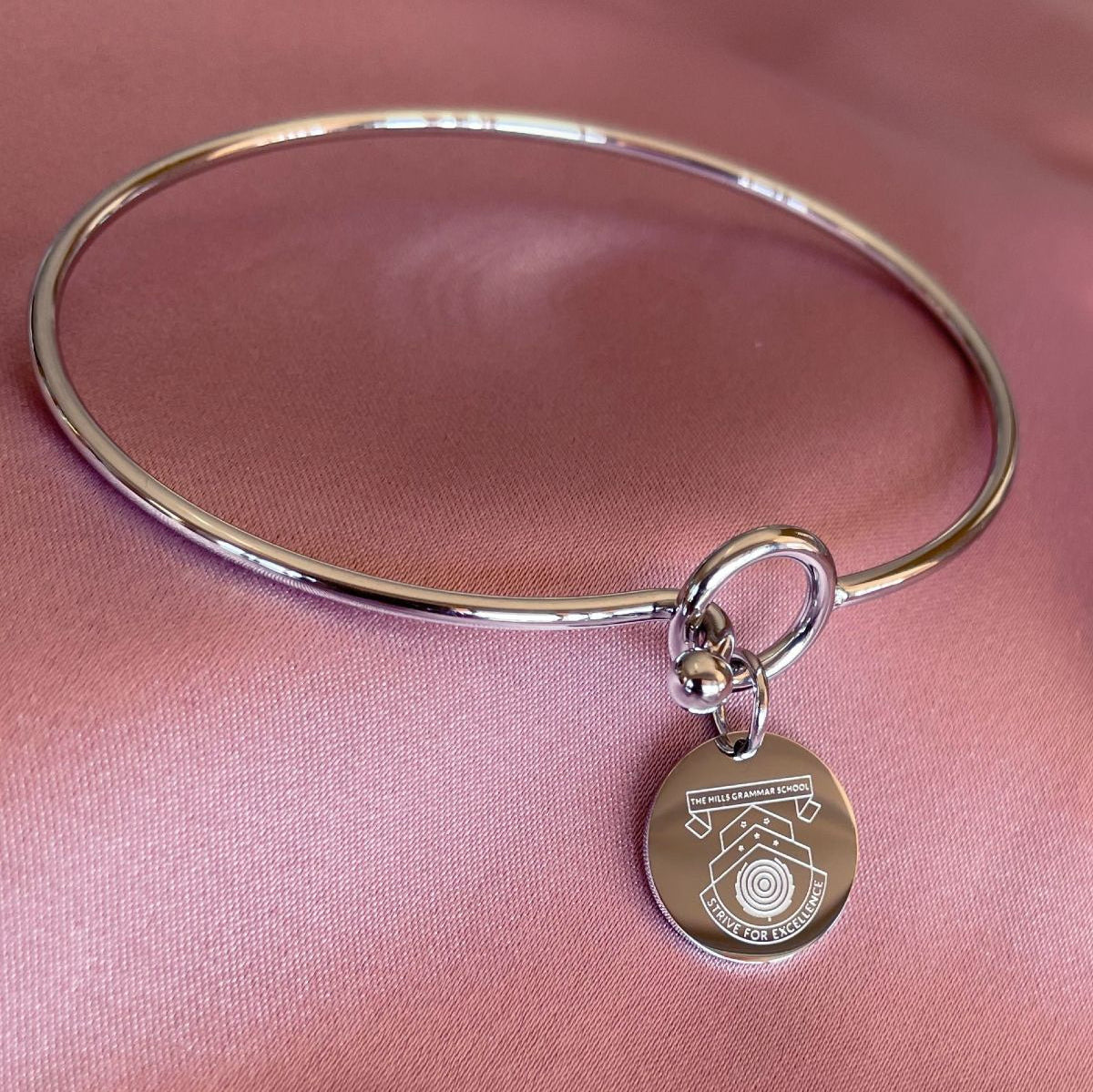 disc bangel with school crest engraved
