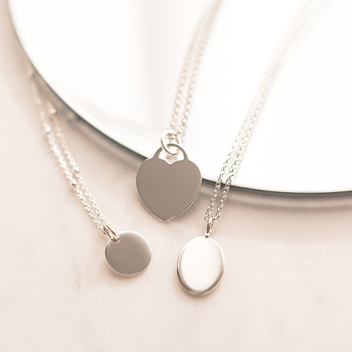 personalise these sterling silver necklaces, disc, heart and oval shapes