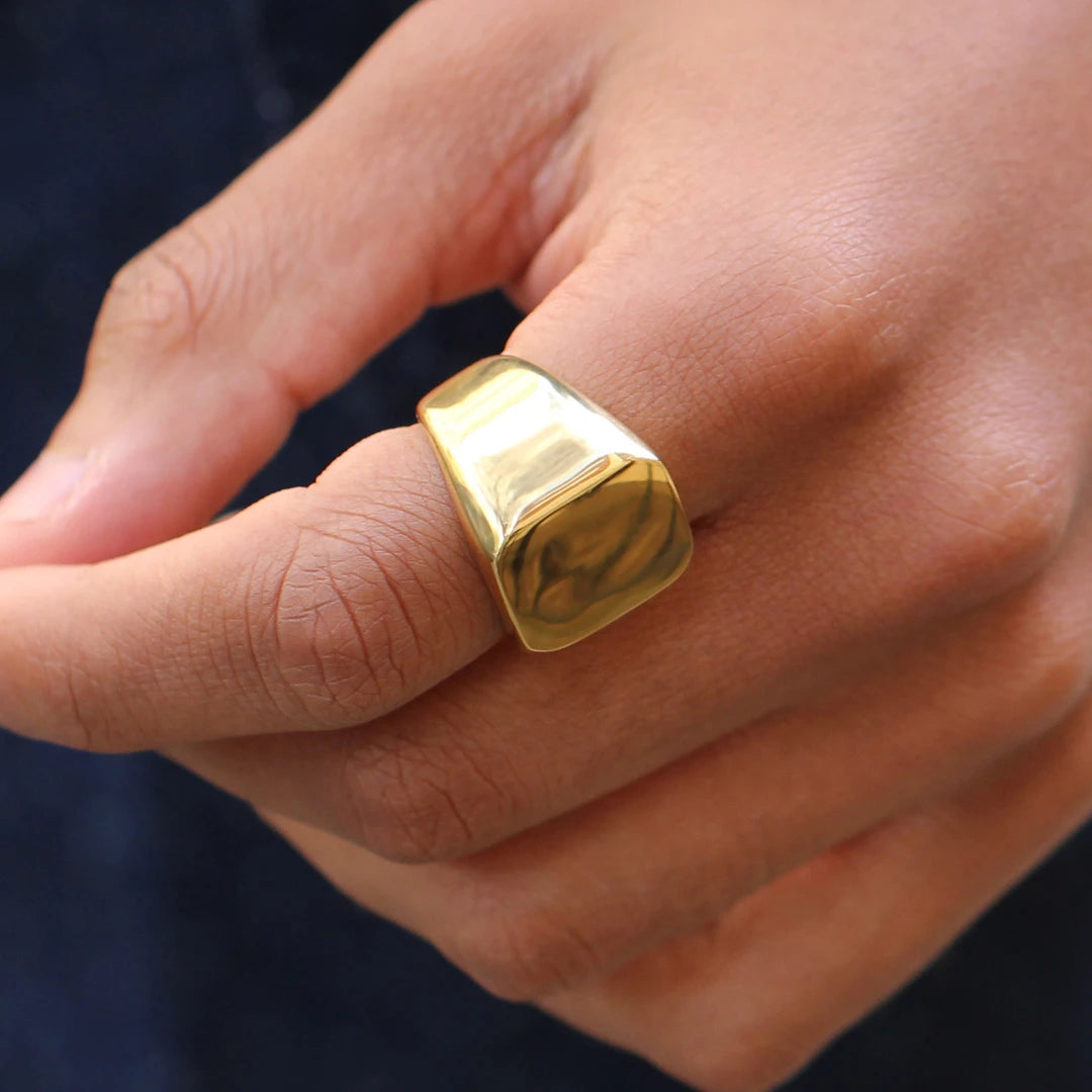Gold ring on a person's finger engraving can be added 