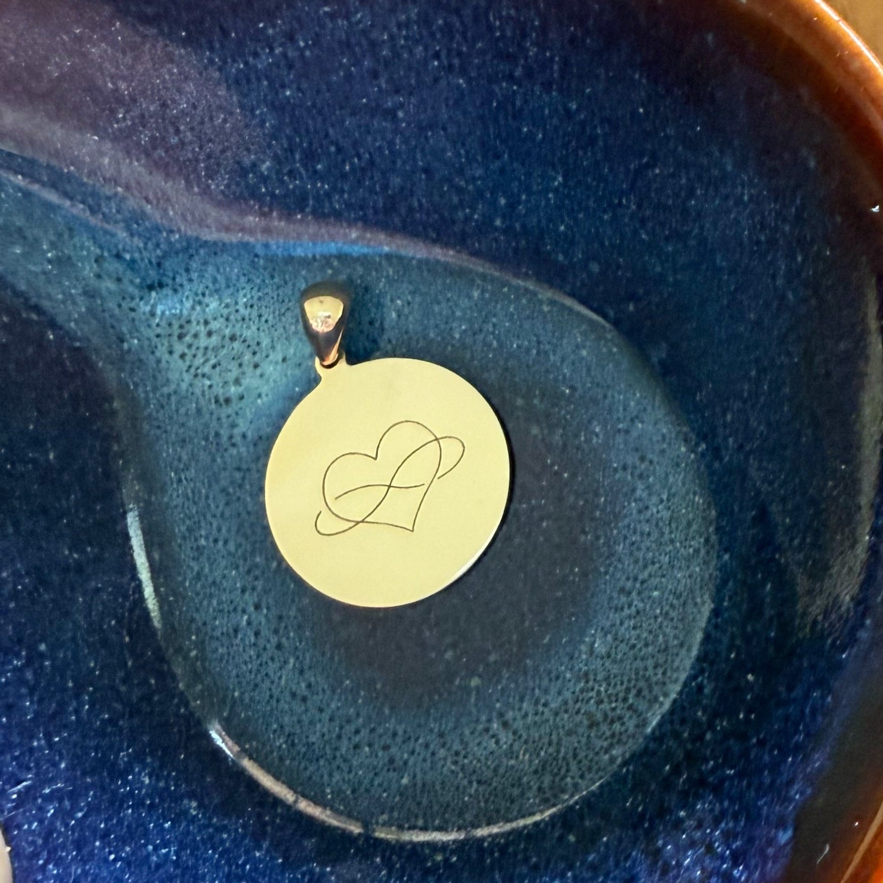 9ct solid gold disc pendant with heart infinity symbol engraved and initials engraved on the reverse. 