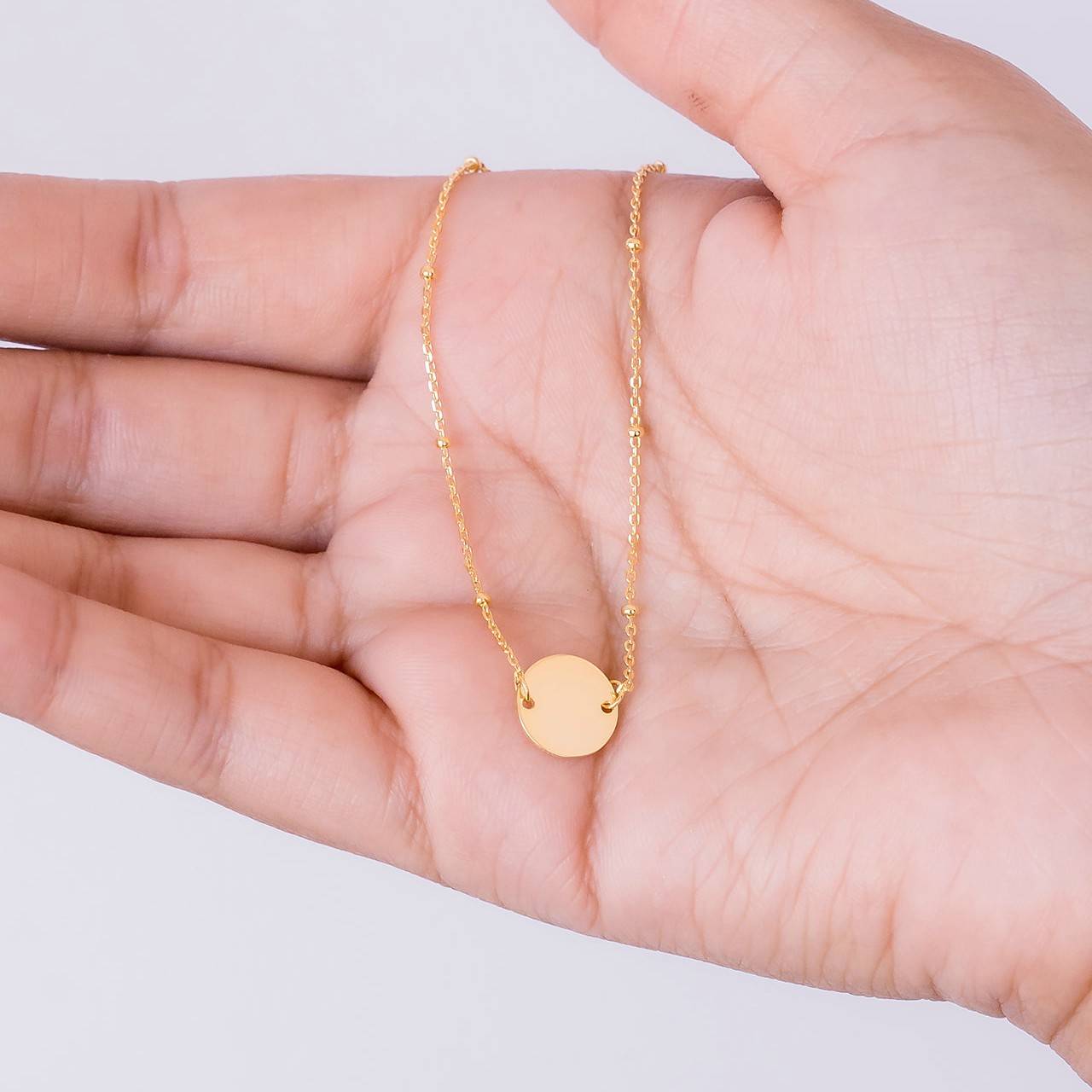 Gold suspended disc bracelet