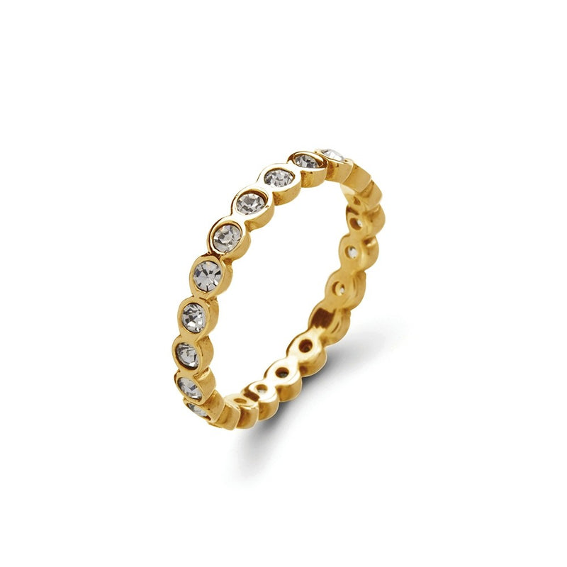 Gold ring with embedded diamante on a white background