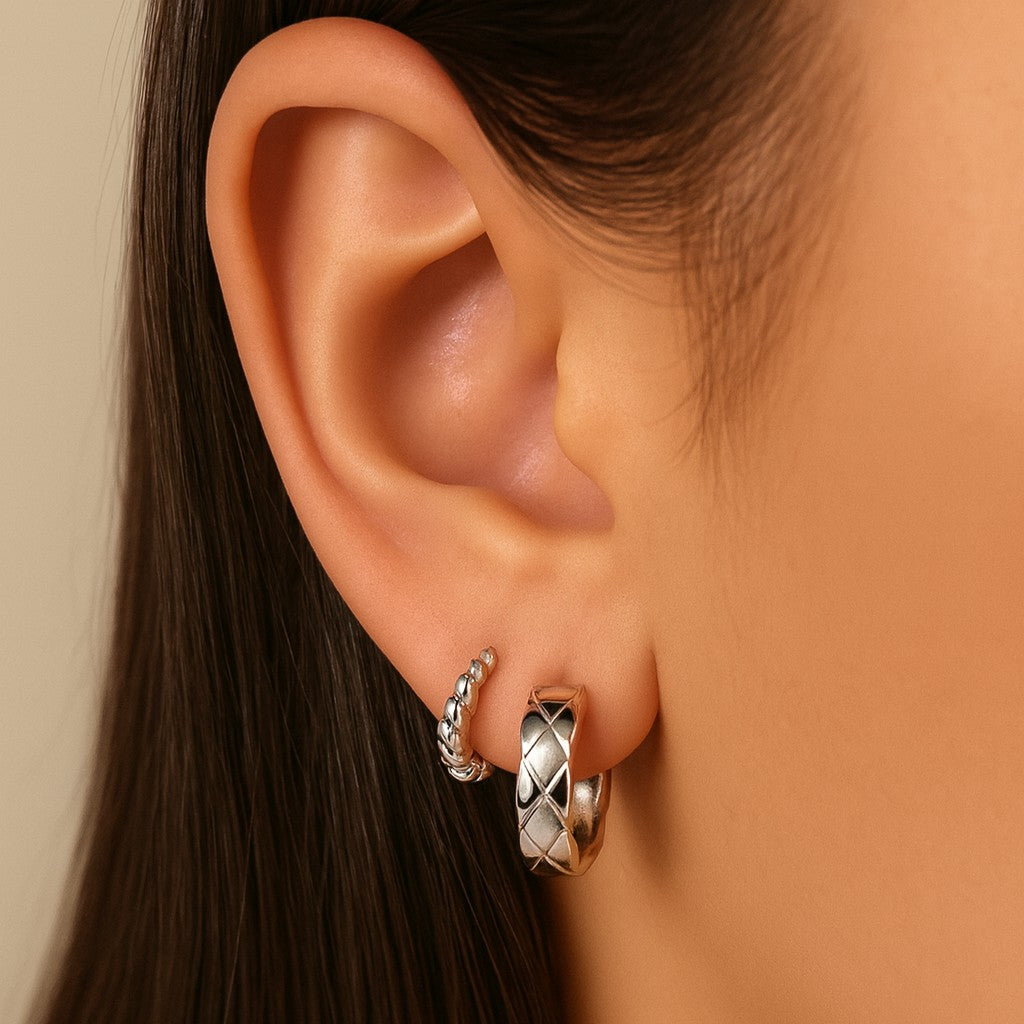 silver earrings stack 14mm twist huggie hoop at back ins second piercing. 