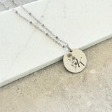 custom engraved disc necklace with initial K and flowers