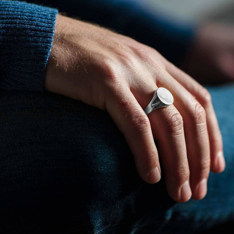 engraved mens round signet ring on hand