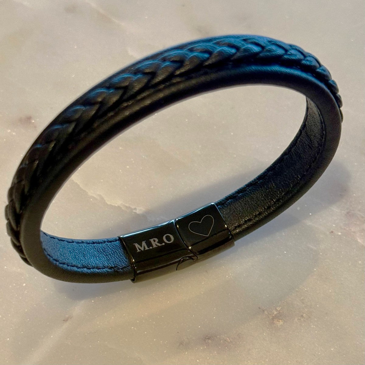 initials and heart engraved on the inside of mens leather bracelet 