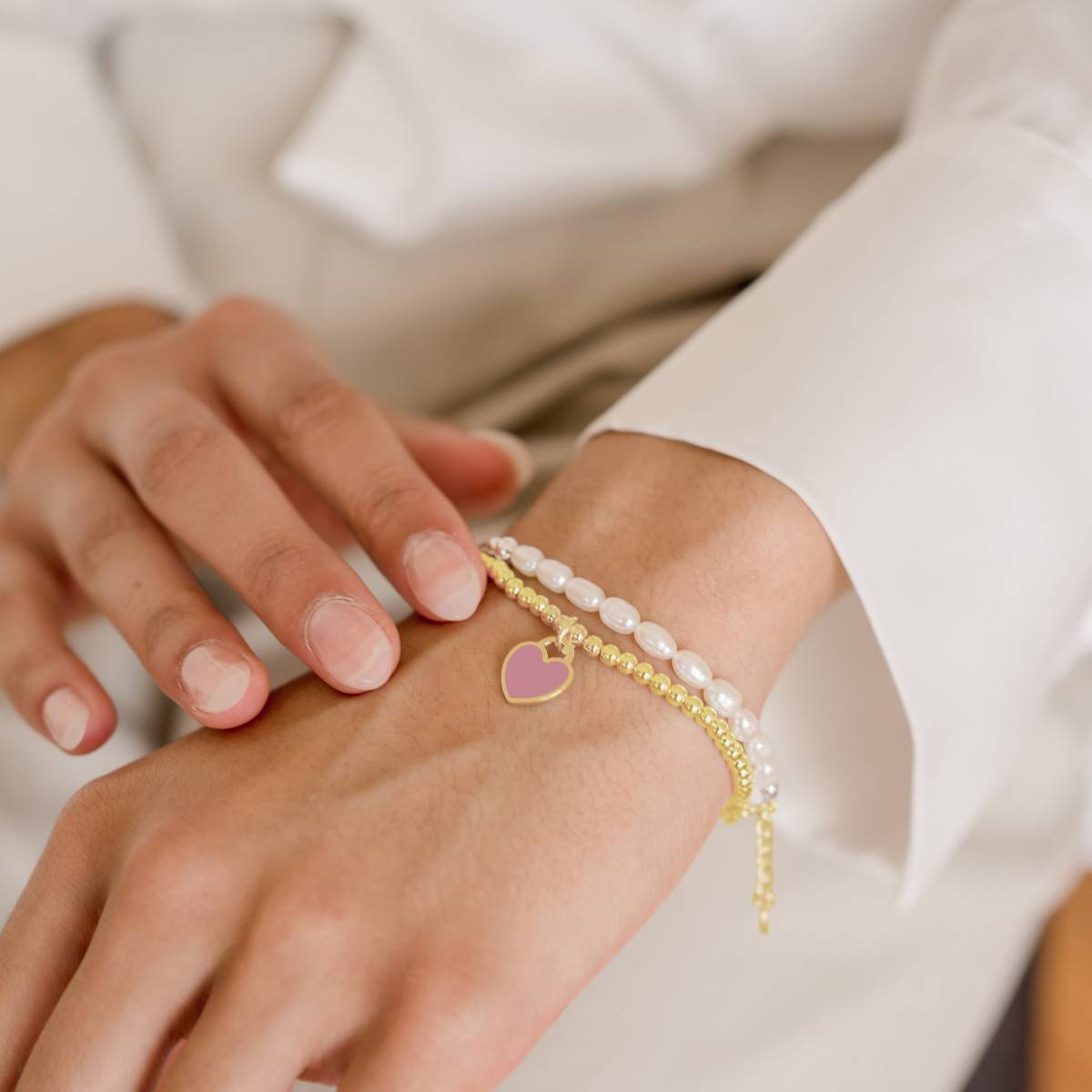 gold stretch bracelet with mini heart pendant