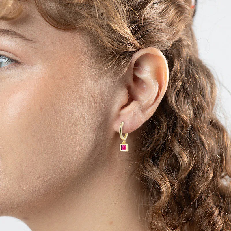 gold huggie earrings with ruby cz drop