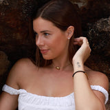 gold pebble necklace with pearl stud earrings and leather id bracelet
