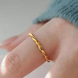 gold twisted rope ring on hand