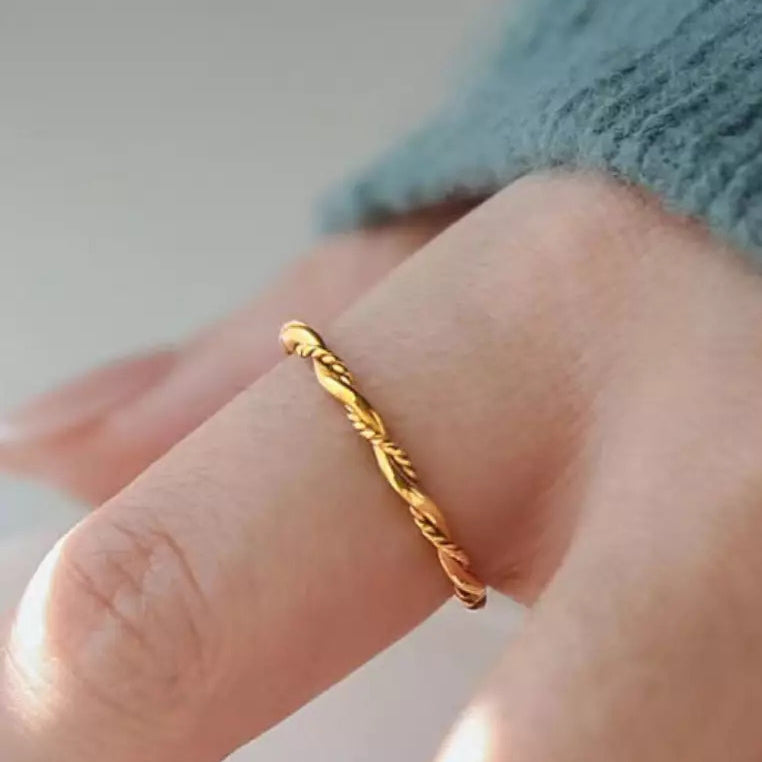 gold twisted rope ring on hand