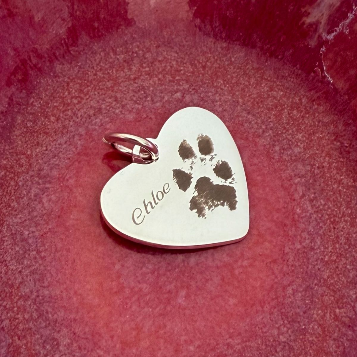 heart pendant engraved with paw print and pets name