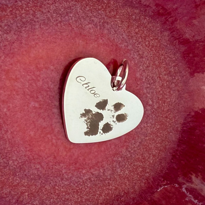 heart pendant engraved with paw print and pets name