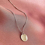 mini disc necklace engraved with mountain design