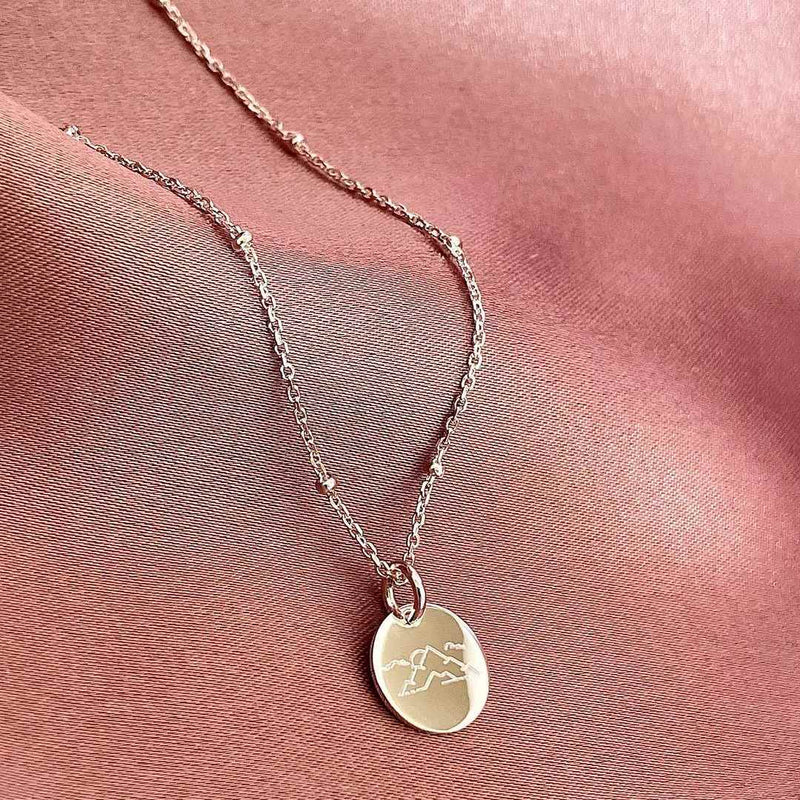 mini disc necklace engraved with mountain design