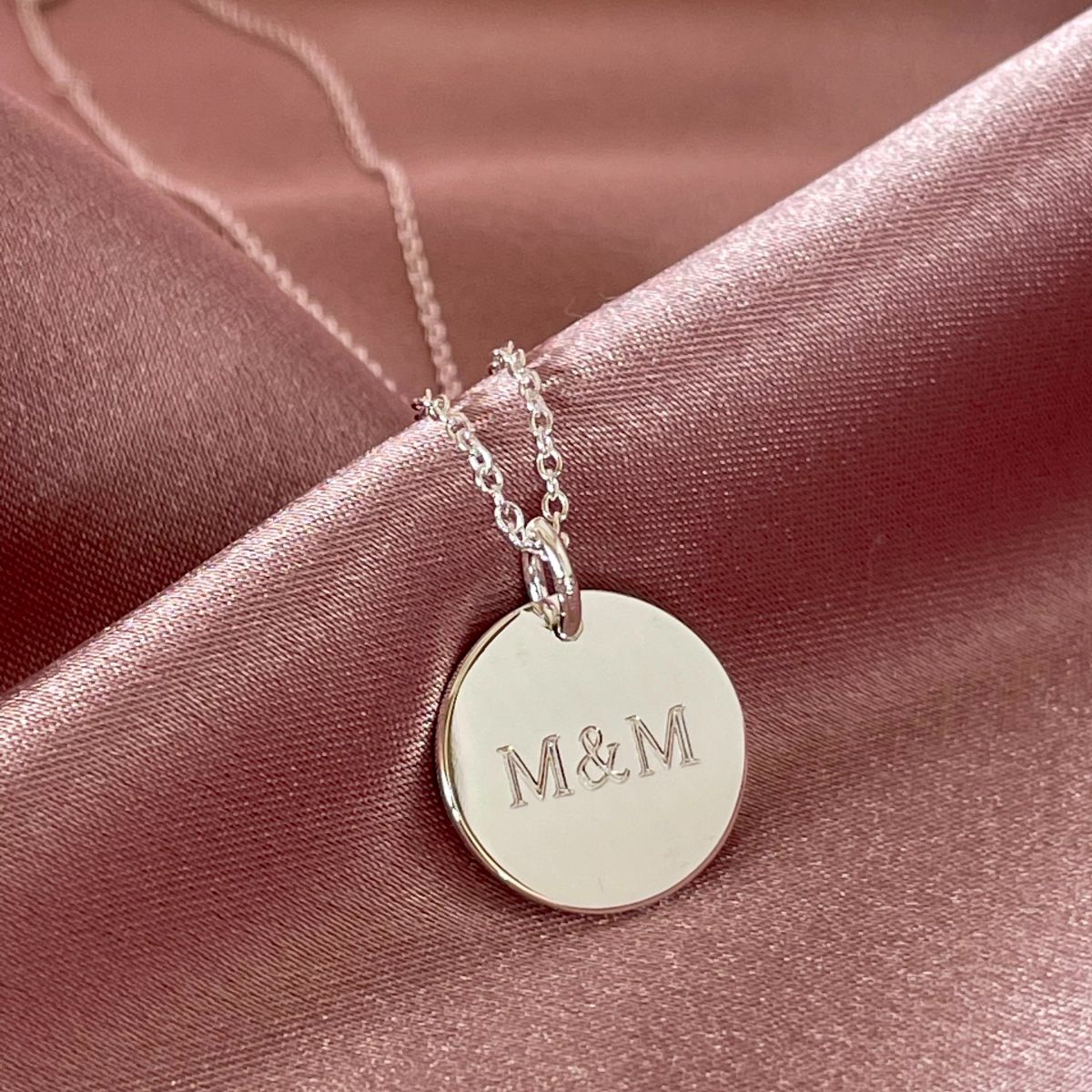 mini disc necklace with initials M & M engraved