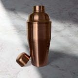 Copper cocktail shaker on a marble surface