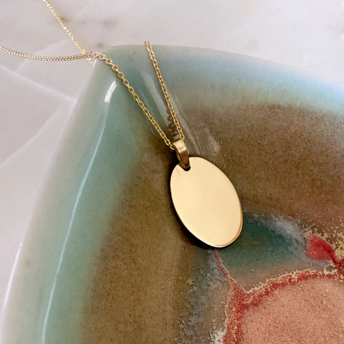 personalise this solid gold oval necklace by engraving