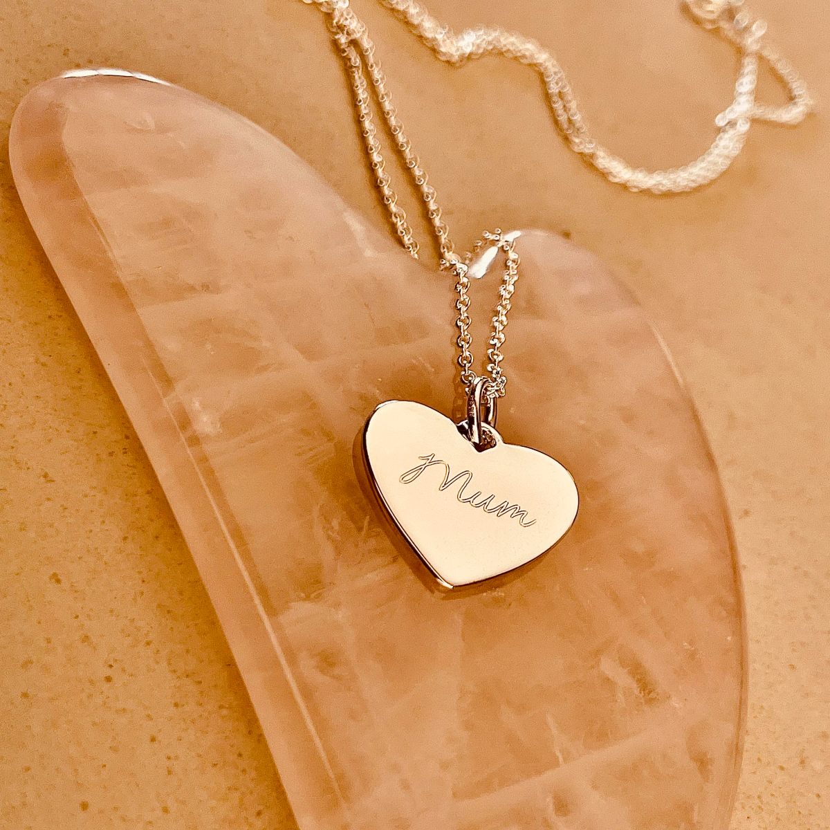 silver heart necklace with Mum engraved on it