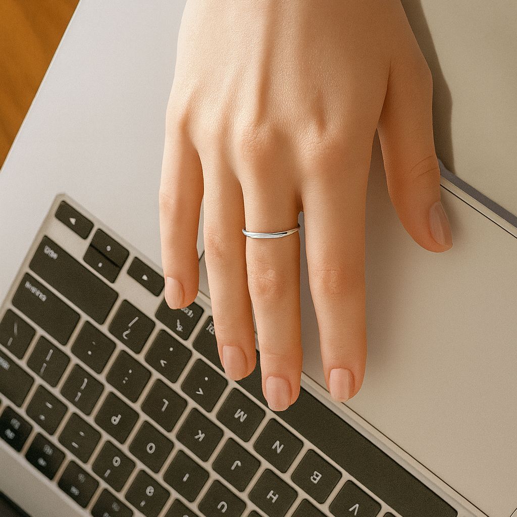 silver steel round band ring size 7 on middle finger of woman's hand