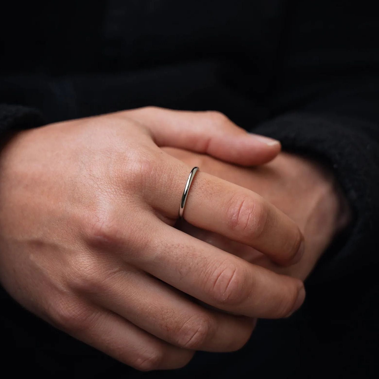 silver steel narrow rounded band ring on mans hand