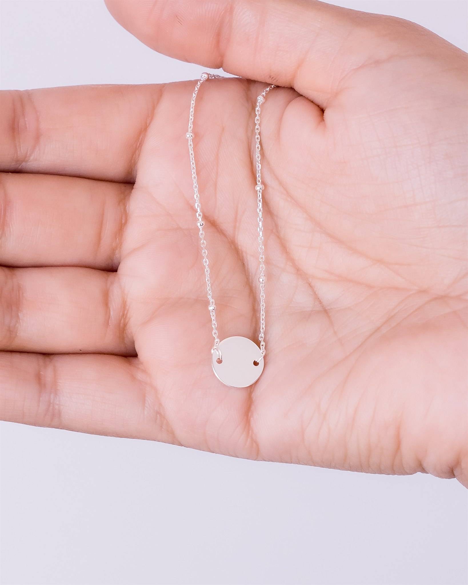 suspended 10mm disc bracelet in hand