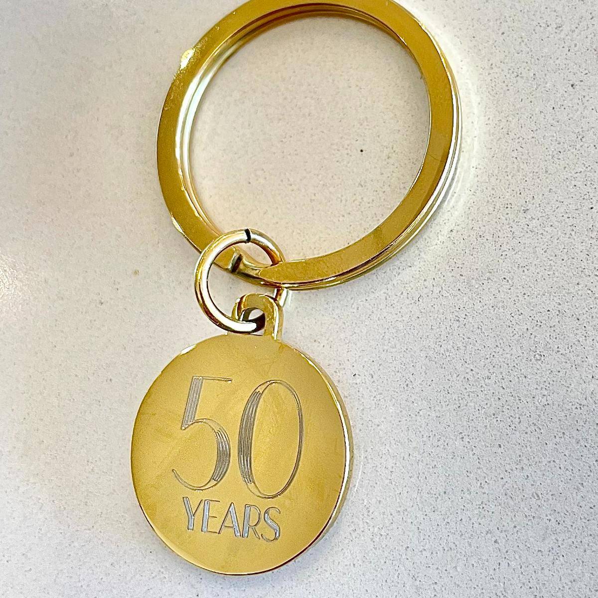 yellow gold coloured disc keyring engraved for 50th anniversary gift