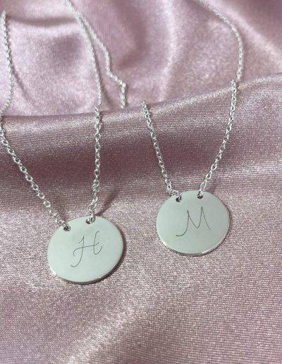 suspended disc necklace with initial H and M engraved