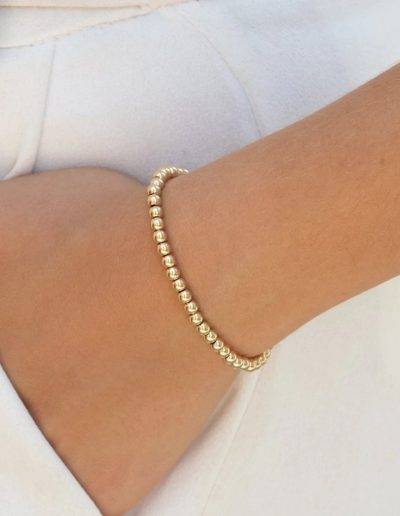 add pendant to this gold stretch bead bracelet