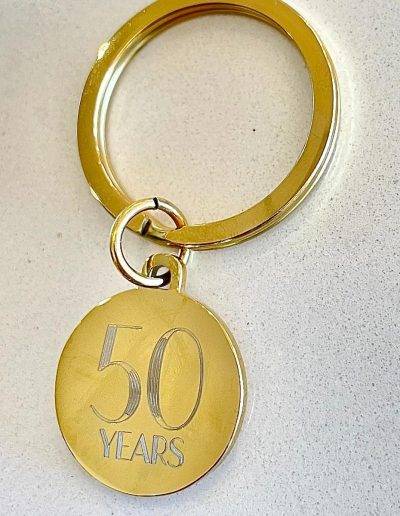 yellow gold coloured disc keyring engraved for 50th anniversary gift