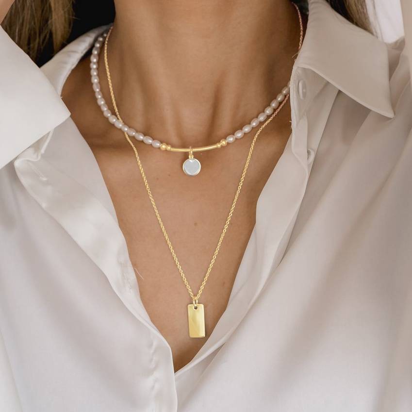 yellow gold bar necklace layered with pearl necklace