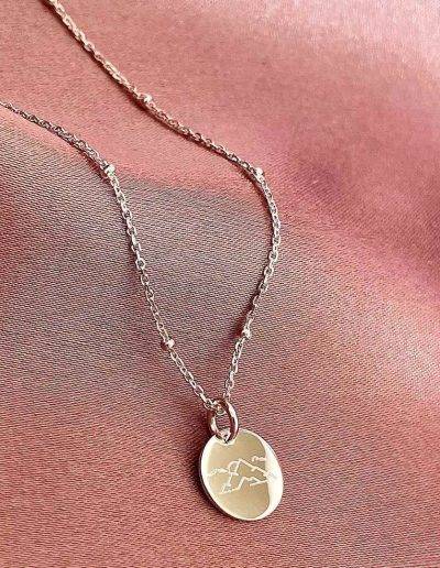 mini disc necklace engraved with mountain design