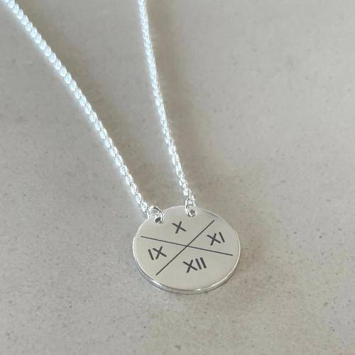 sterling silver suspended disc necklace with intials engraved around crossed lines